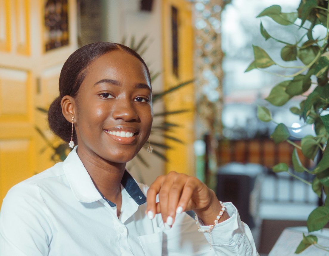 A smiling asset owner at her desk